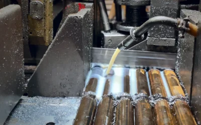 Band saw cutting several steel bars under coolant Band saw cutting several steel bars under coolant