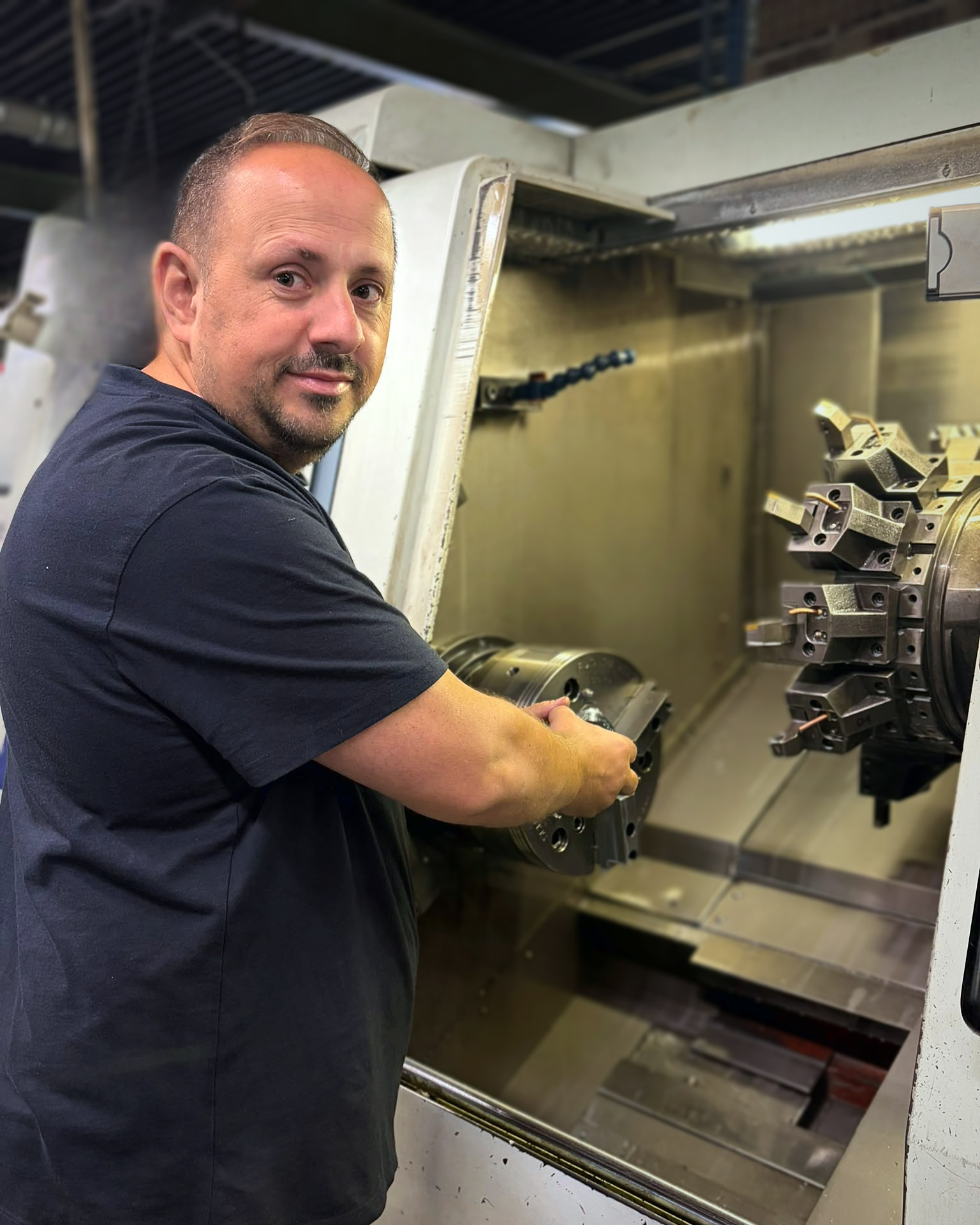 Anel Rastoder setting up the chuck of a CNC lathe